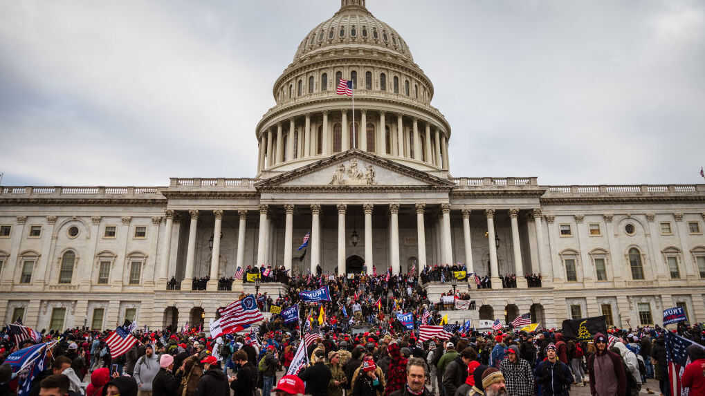 WASHINGTON, DC - JANUARY 06: A large group of pro-Trump protesters stand on the East steps of the Capitol Building after storming its grounds on January 6, 2021 in Washington, DC. A pro-Trump mob stormed the Capitol, breaking windows and clashing with police officers. Trump supporters gathered in the nation's capital today to protest the ratification of President-elect Joe Biden's Electoral College victory over President Trump in the 2020 election. (Photo by Jon Cherry/Getty Images)